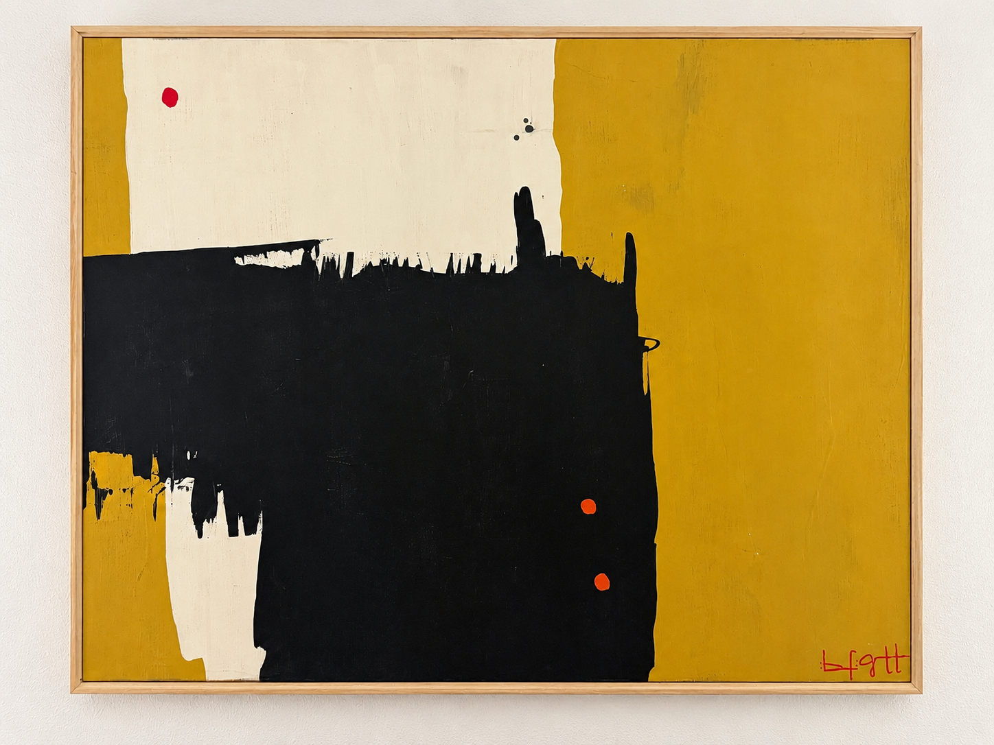 Abstract painting in ochre, black, and cream with bold gestural strokes and red accents in a natural wood frame